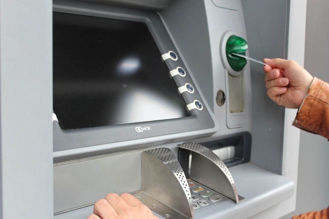 Person placing his card on an ATM machine