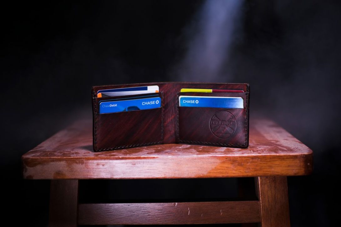 Brown wallet opened to see Chase credit cards visible in the card sections