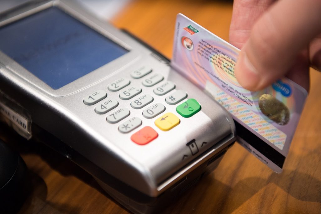 A credit card being swiped on the terminal payment