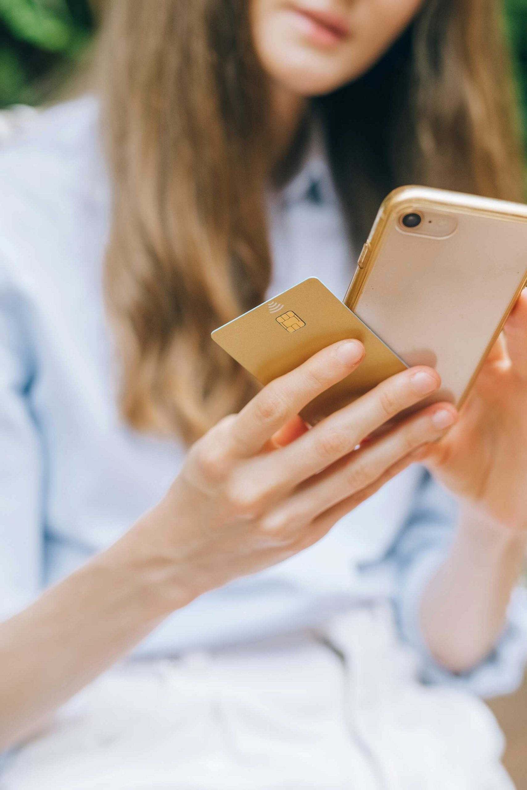 A woman holding her credit card and phone