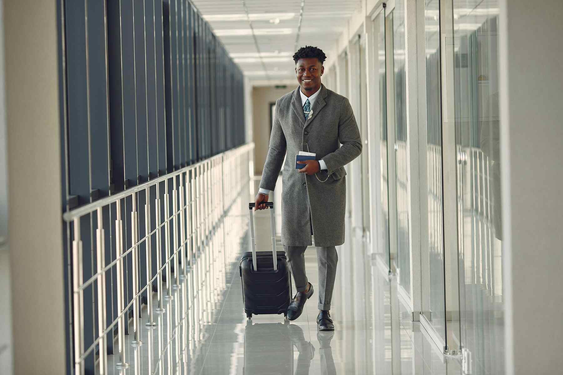 A man holding his luggage for a business trip