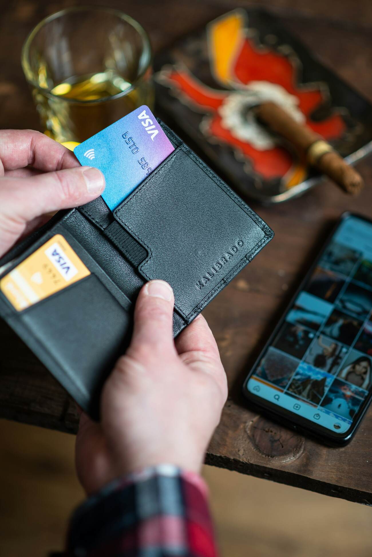 A sleek black leather wallet with multiple card slots and a cash compartment